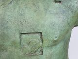 sculpture of a man ' s torso with a square in the middle