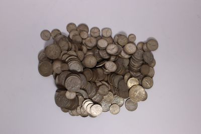 une pile de pièces d'argent sur une surface blanche