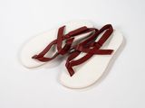 a close up of a pair of sandals on a white surface