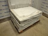 a stack of mattresses sitting on a pallet in a room