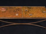 a small table with a metal base and a glass top