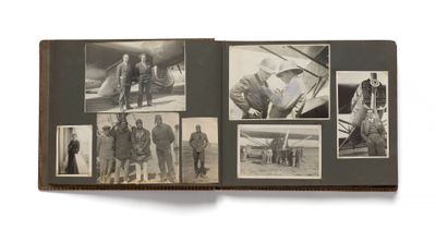 an old photo of a group of people standing in front of an airplane