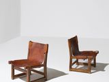 deux fauteuils en cuir marron posés sur un sol blanc