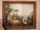 a painting hanging on the wall next to a lamp
