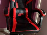 a black and red office chair in the corner of a room