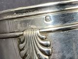 a close up of a silver vase on a table
