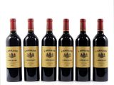 six bottles of red wine lined up in a row on a white surface
