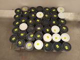 a lot of black and white cups and lids on the floor