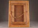 an old wooden picture frame with a rope hanging from it