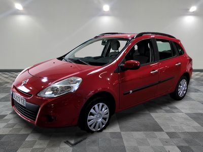 the small red car is parked in the room on a checkered floor