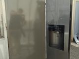 an image of a stainless steel refrigerator in a room