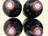 three bottles of wine are lined up on a table