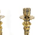 pair of antique brass candlesticks with floral designs on each of them
