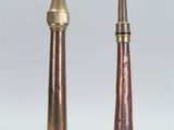 pair of antique brass candlesticks on a white background