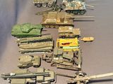 a lot of toy army vehicles and tanks on a table