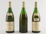 three bottles of wine sitting next to each other on a white surface