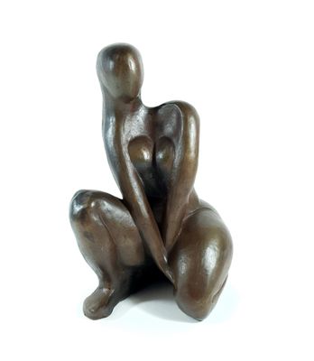 statue of a woman sitting on her knees on a white surface
