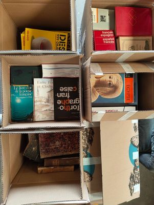 boxes of books are stacked on top of each other in a room