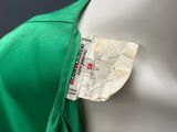 an image of a close up of a green shirt with a tag on it