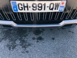 a close up of the front of a car with a number plate on it