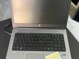 a laptop computer sitting on a table with a sticky note on it