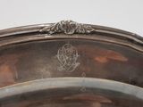 a silver plate with a decorative design on it