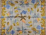 an image of a square scarf with shells and starfishs on it