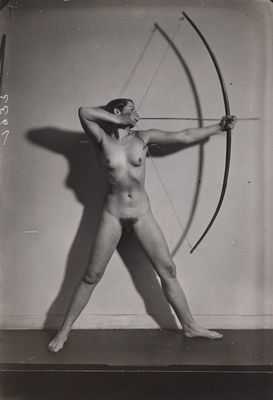 an old black and white photo of a naked woman holding a bow and arrow
