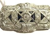 an antique silver belt buckle with a blue stone in the center