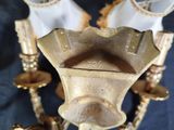 a gold colored chandelier with three lights on it