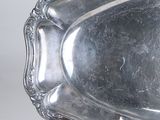 a silver plate with a decorative design on it