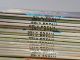 a lot of books that are stacked on top of each other