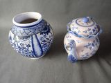 two blue and white vases sitting next to each other