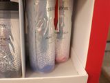 two bottles that are sitting on a shelf in the bathroom