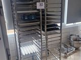 a metal rack with several trays of food on it