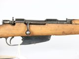 an old rifle with a wooden barrel on a white background