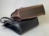 two pieces of black and brown leather are stacked on top of each other