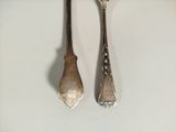 two spoons and a fork sitting on a table