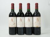 three bottles of wine are lined up on a white surface