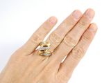 a woman ' s hand with two rings on it