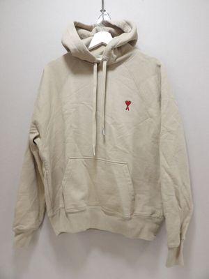 the hoodie is hanging on a hanger on the wall