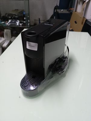 a coffee machine sitting on top of a white table