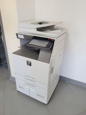 a white printer sitting on top of a white cabinet