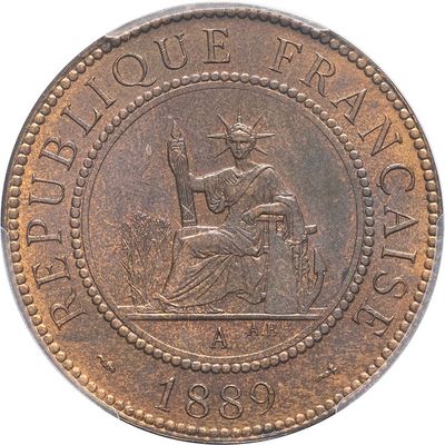a close up of a coin with the image of a woman sitting on a chair