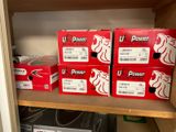 boxes of u power products are stacked on a shelf in a closet