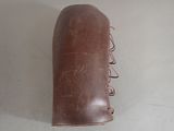 a brown leather bag with a handle on a table