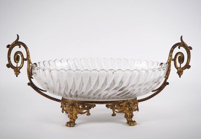 un bol en verre ancien orné de motifs dorés, posé sur un socle