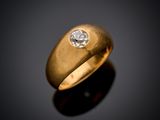a close up of a gold ring with a diamond on a black surface