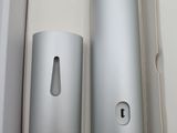 a white box with two silver cylinders in it