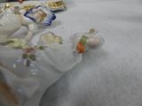 a figurine of a woman laying on a bed